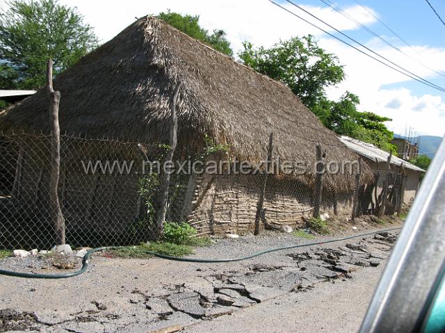 tecuiziapan_nahuatl22.JPG - Another bamboo, adobe and thatched roof home next to a newer house made of concrete blocks.
